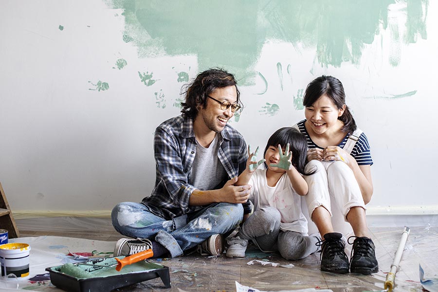 Personal Insurance - Father, Young Daughter and Mother Sit on the Floor Surrounded by Painting Supplies, Little Girl Showing Her Paint-Covered Hands